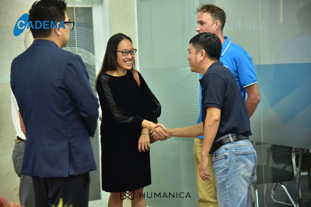 A Cadena team member shaking hands with a guest on the new floor